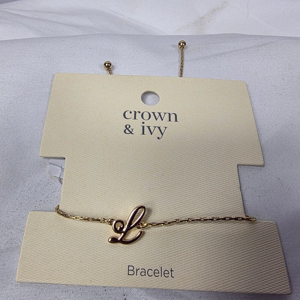 Crown & Ivy gold-tone initial bracelet featuring a cursive letter "L" charm